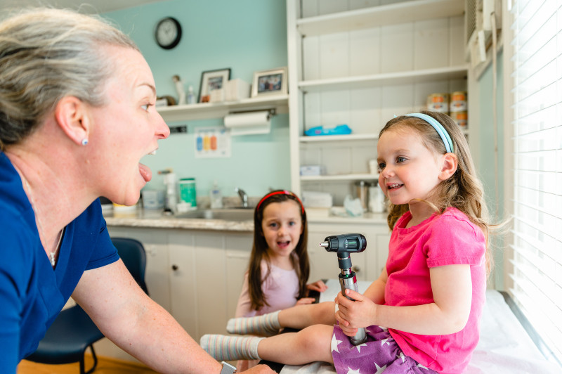 girls examining a pediatrician
