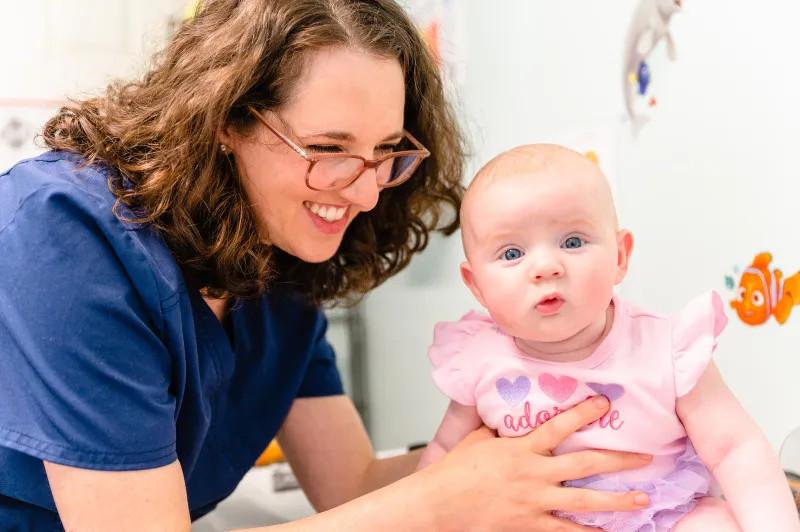 a provider holding up a baby