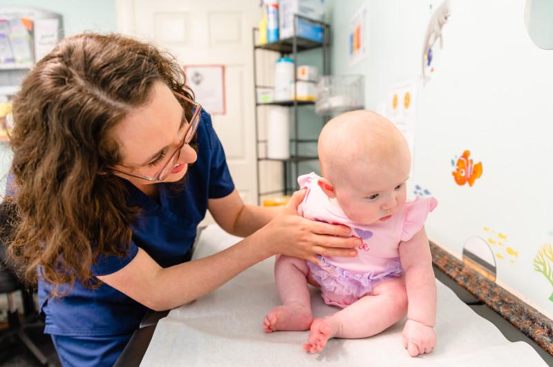 a provider giving an exam to a baby