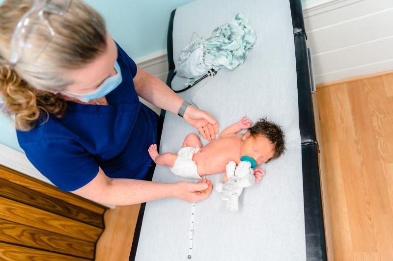 a provider giving an exam to an infant