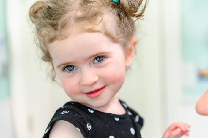 a young girl smiling